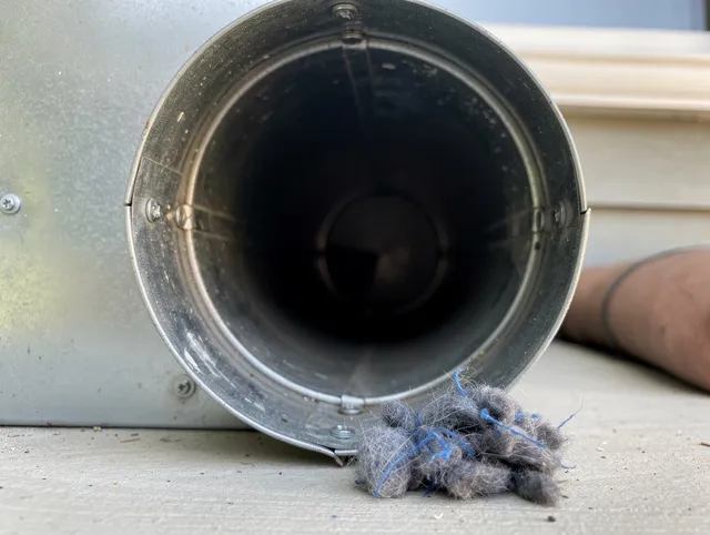 Pinellas Park Dryer Vent Cleaning technician using specialized equipment to clear severe dryer vent blockage in Pinellas Park